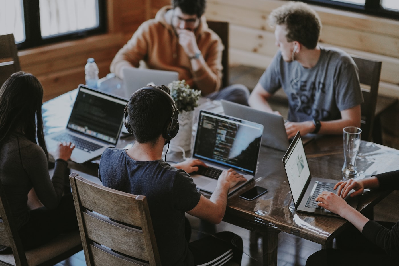 Collaborators reviewing notes around laptops