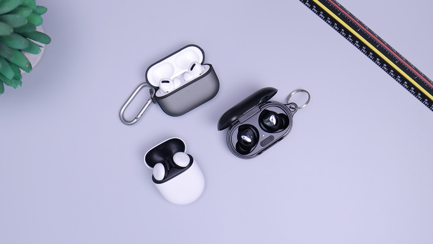 Wireless earbuds in a charging case held during a city commute