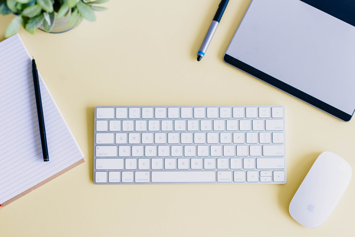 Mechanical keyboard on a wooden desk beside a coffee mug