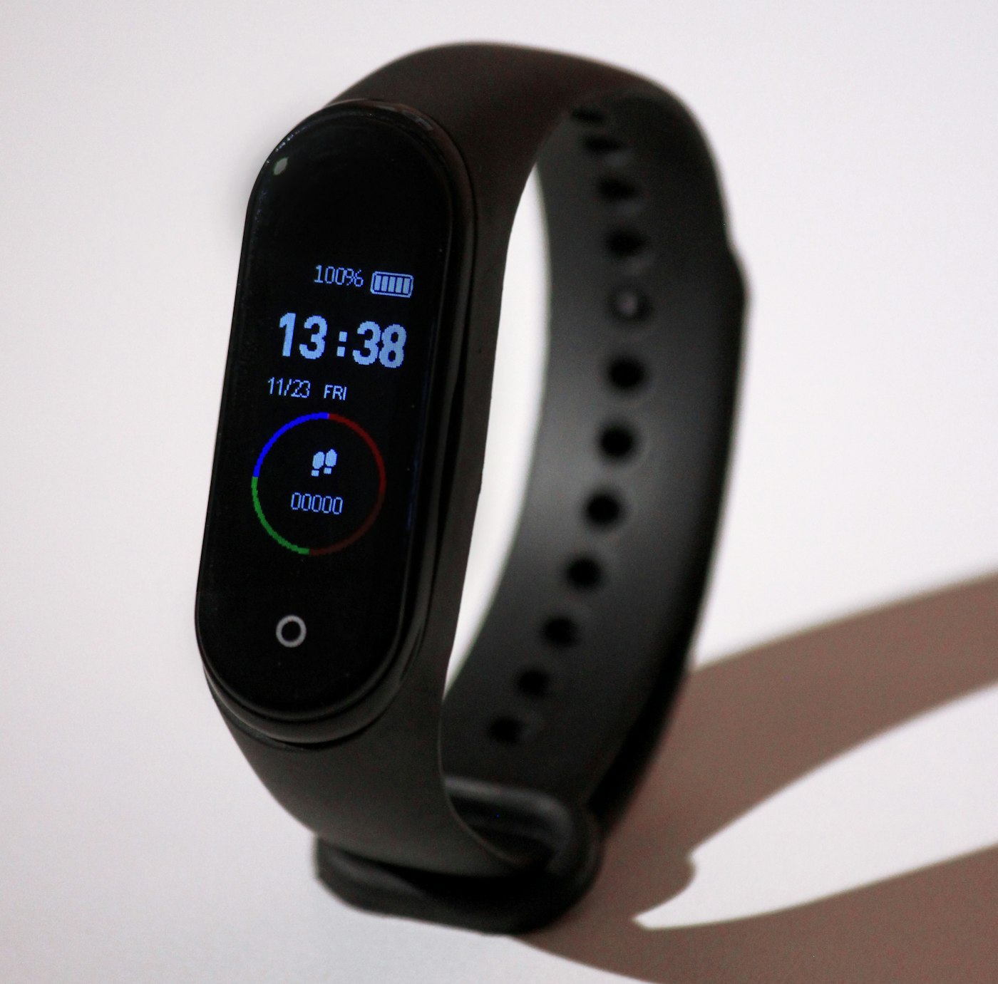 Runner checking a smartwatch on a park path